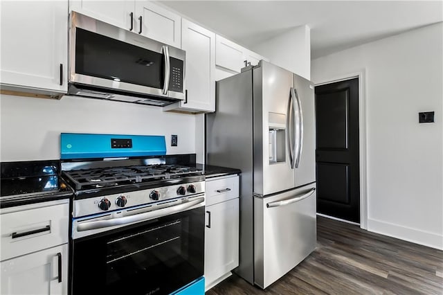 kitchen with white cabinets, dark hardwood / wood-style floors, and appliances with stainless steel finishes