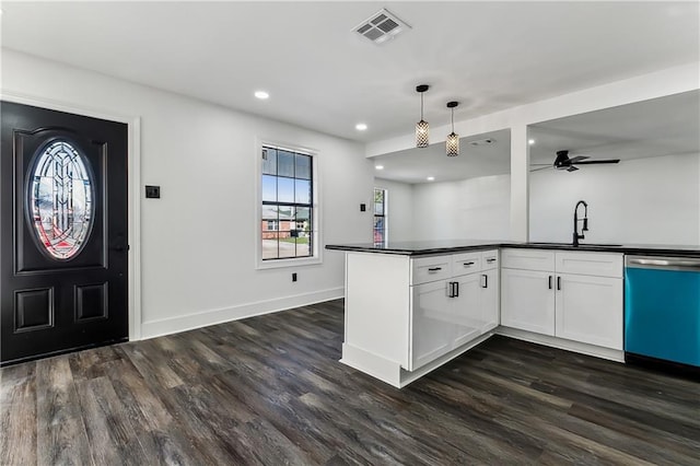 kitchen featuring ceiling fan, sink, hanging light fixtures, stainless steel dishwasher, and white cabinets