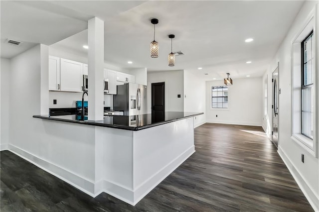 kitchen with sink, hanging light fixtures, stainless steel appliances, dark hardwood / wood-style floors, and white cabinets