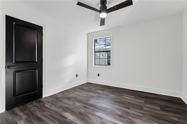 spare room featuring ceiling fan and dark wood-type flooring