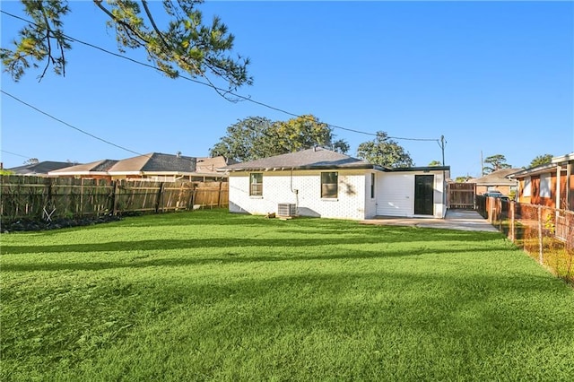 back of house with a yard and a patio