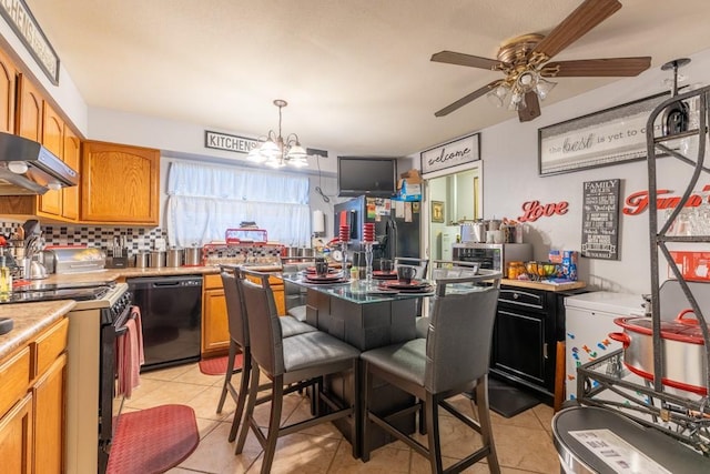 kitchen featuring ceiling fan with notable chandelier, pendant lighting, dishwasher, range with gas stovetop, and light tile patterned flooring