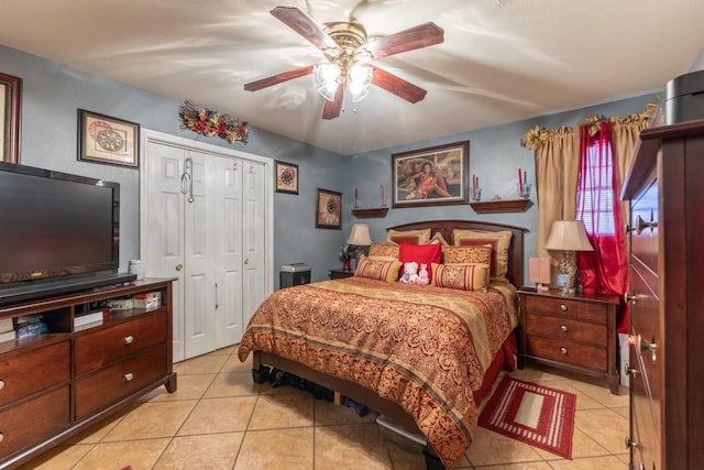 tiled bedroom featuring ceiling fan and a closet