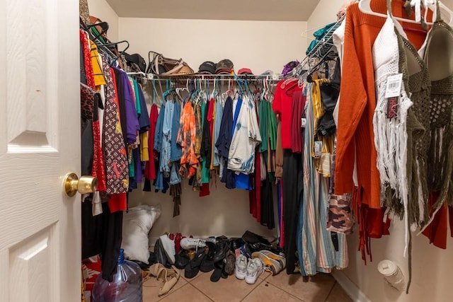 spacious closet with tile patterned floors