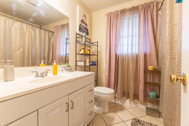 bathroom featuring toilet, vanity, and tile patterned floors