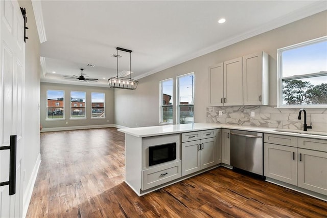 kitchen featuring sink, black microwave, stainless steel dishwasher, ornamental molding, and kitchen peninsula