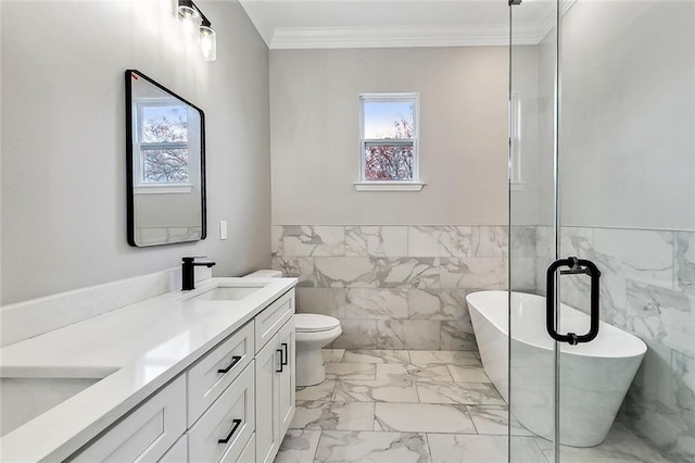 bathroom with toilet, crown molding, tile walls, vanity, and a washtub