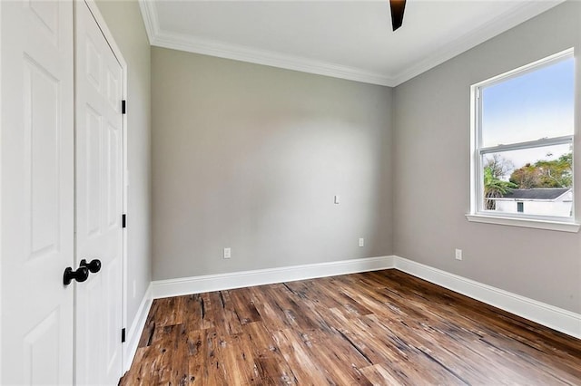 unfurnished bedroom featuring hardwood / wood-style flooring, ornamental molding, a closet, and ceiling fan