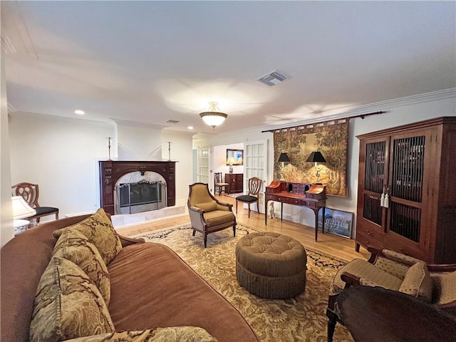 living room with wood-type flooring, crown molding, and french doors