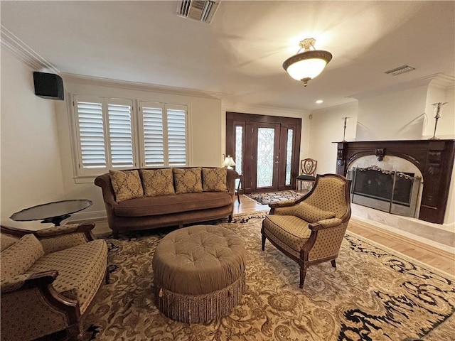 living room with crown molding and hardwood / wood-style floors