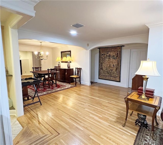 sitting room featuring crown molding and a chandelier