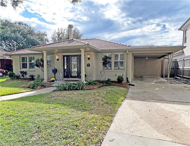 view of front facade with a carport and a front lawn