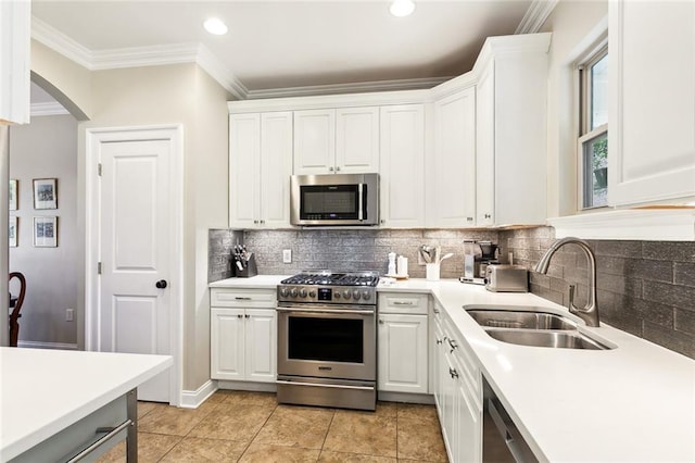 kitchen with white cabinets, light tile patterned flooring, sink, and stainless steel appliances