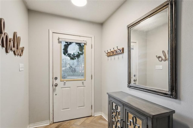 doorway to outside with light parquet flooring