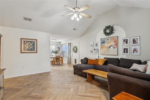 living room featuring ceiling fan, light parquet flooring, and vaulted ceiling