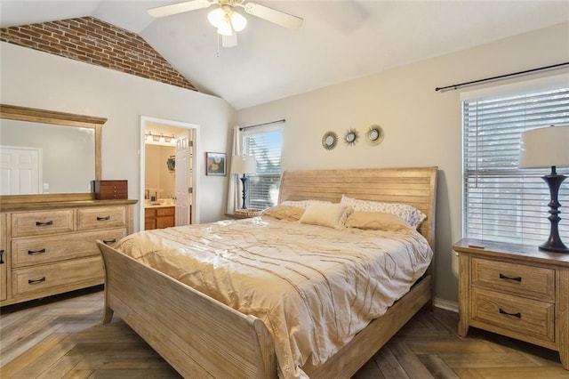 bedroom with ceiling fan, dark parquet flooring, connected bathroom, and multiple windows