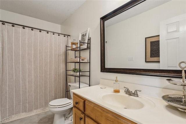 bathroom featuring tile patterned flooring, vanity, and toilet