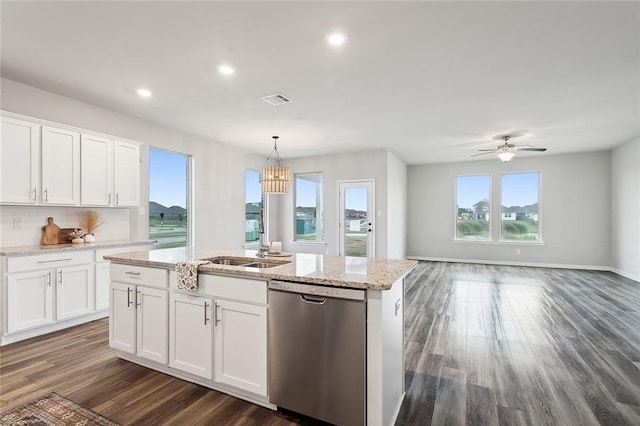 kitchen with dark wood-type flooring, white cabinetry, decorative light fixtures, a center island with sink, and dishwasher