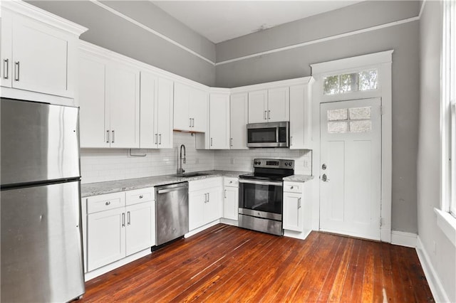 kitchen featuring white cabinets, dark wood-type flooring, and appliances with stainless steel finishes