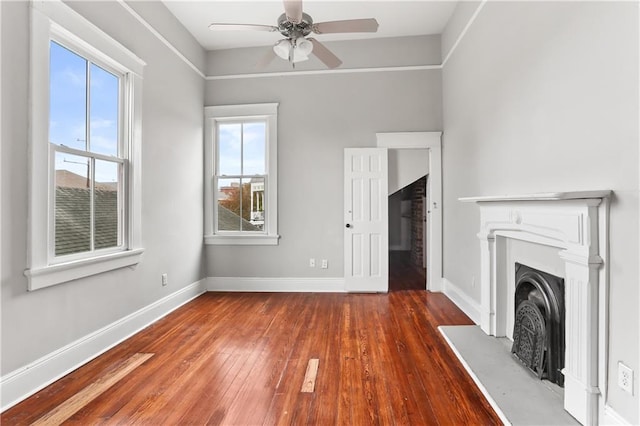 unfurnished living room featuring dark hardwood / wood-style floors and ceiling fan