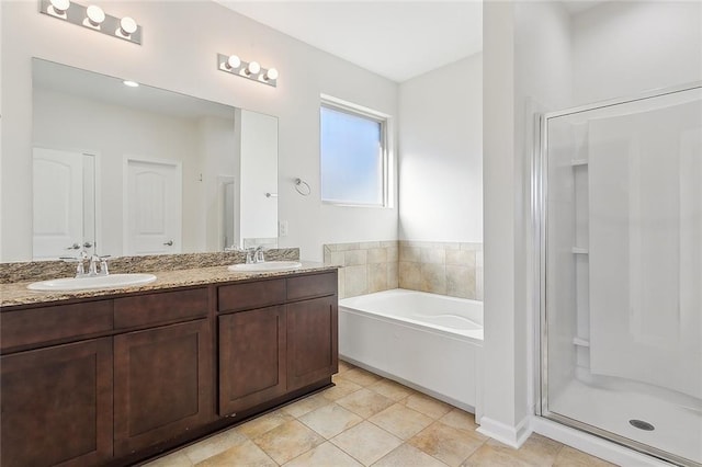 bathroom with tile patterned floors, vanity, and shower with separate bathtub