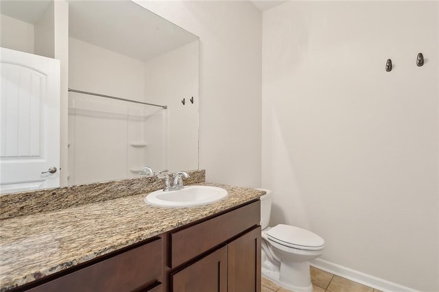 bathroom with toilet, vanity, tile patterned floors, and walk in shower