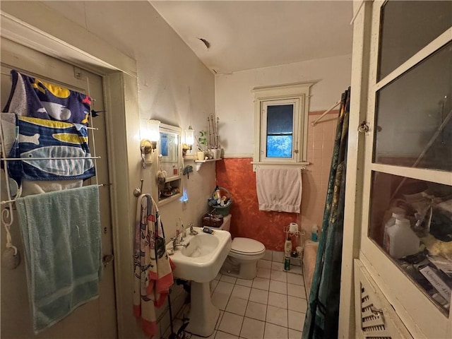 bathroom with tile patterned flooring, sink, toilet, and walk in shower