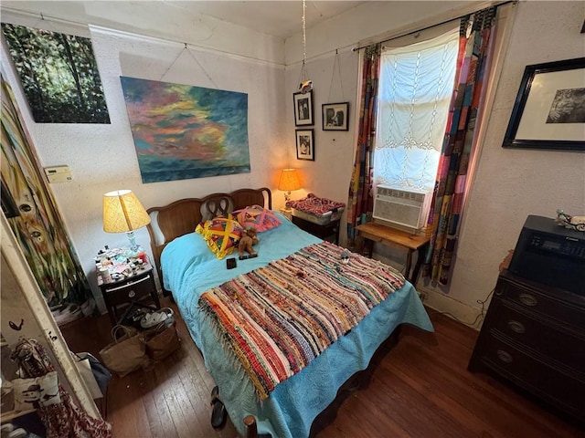 bedroom featuring dark hardwood / wood-style floors and cooling unit