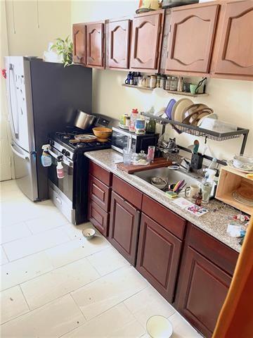 kitchen with a sink, light countertops, and gas stove