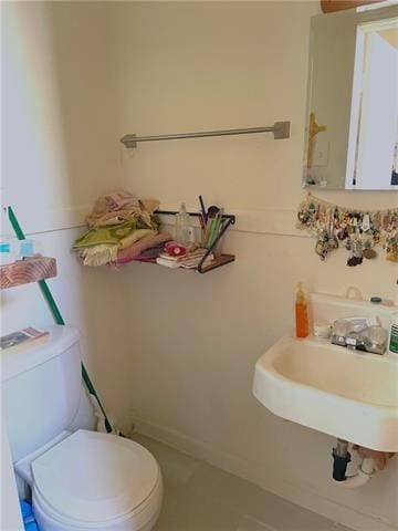half bathroom with toilet and a sink