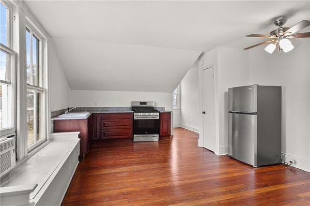 kitchen featuring a healthy amount of sunlight, dark wood-style floors, and stainless steel appliances