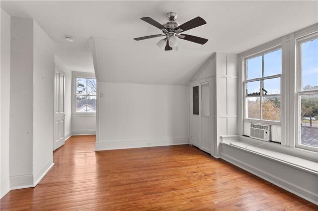 bonus room featuring cooling unit, light wood finished floors, a ceiling fan, and vaulted ceiling