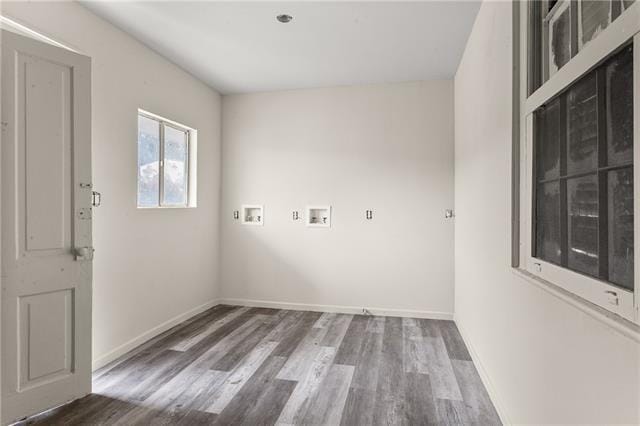 unfurnished room featuring baseboards and wood finished floors