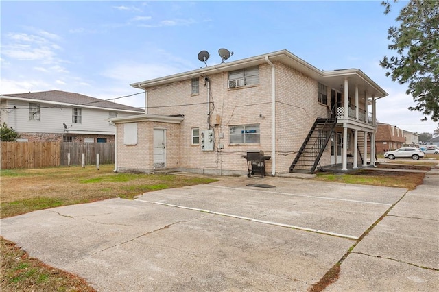 rear view of property with a yard