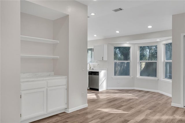 unfurnished dining area with light wood-type flooring and sink