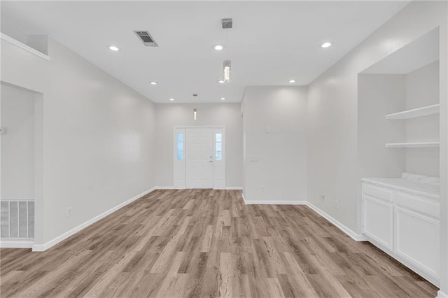 empty room with light hardwood / wood-style flooring