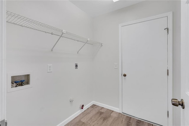 laundry area with electric dryer hookup, gas dryer hookup, hookup for a washing machine, and hardwood / wood-style flooring