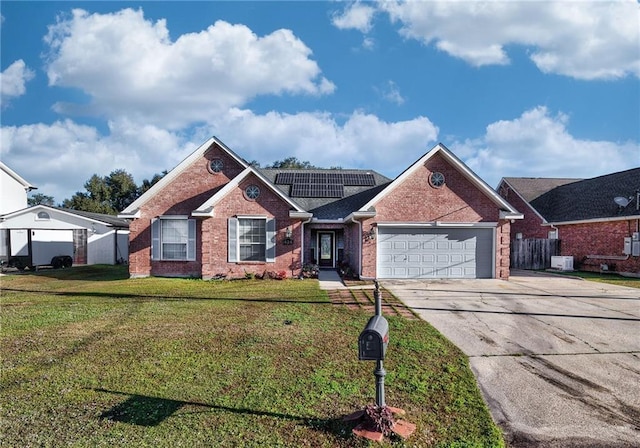 view of front of house featuring a front yard, solar panels, and a garage