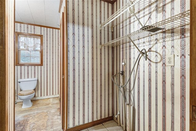 bathroom with toilet and crown molding