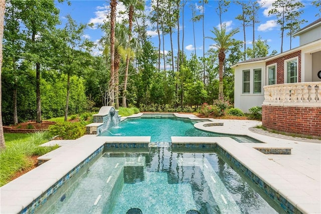 view of swimming pool featuring pool water feature and an in ground hot tub