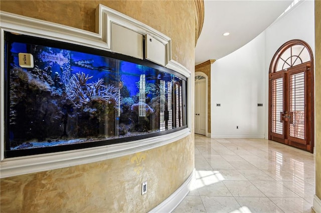 interior space with a high ceiling and french doors