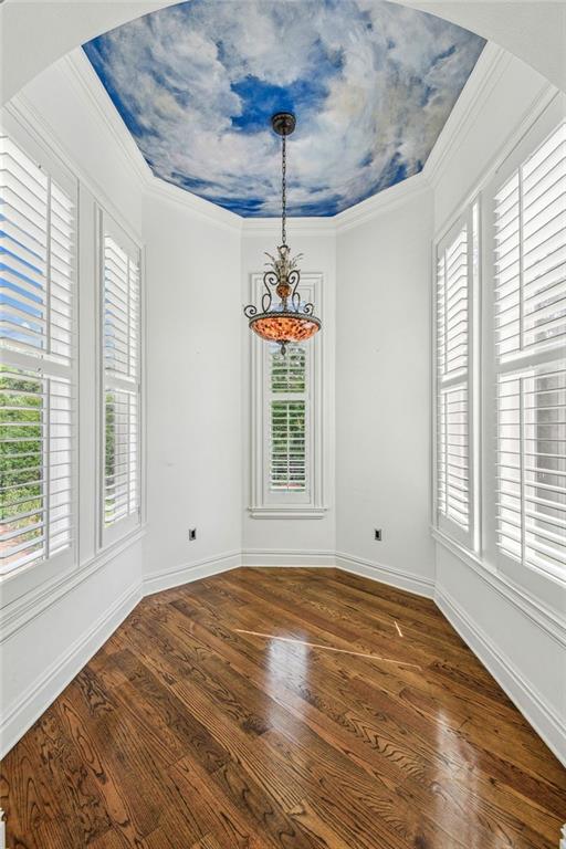 unfurnished dining area with ornamental molding, dark hardwood / wood-style flooring, and plenty of natural light