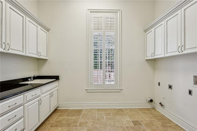 washroom with cabinets, hookup for an electric dryer, hookup for a washing machine, sink, and gas dryer hookup