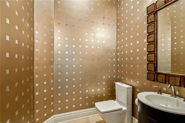 bathroom featuring toilet, vanity, and tile patterned floors