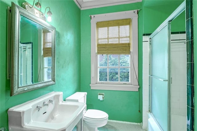 full bathroom with tile patterned floors, sink, enclosed tub / shower combo, and toilet