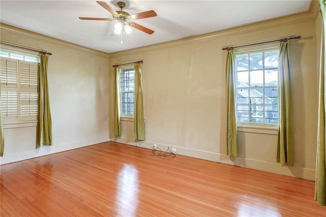 empty room with ceiling fan, a healthy amount of sunlight, and ornamental molding