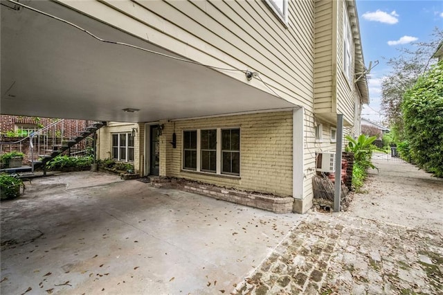 view of patio featuring a carport and a wall mounted AC