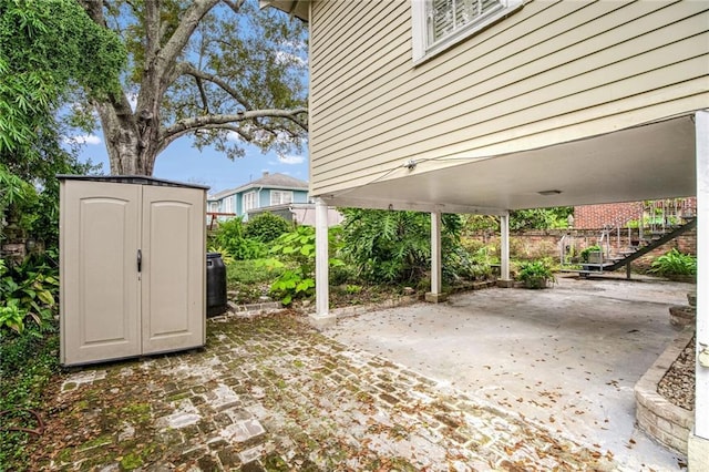 view of patio featuring a storage unit