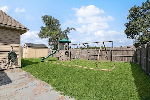 view of yard with a storage shed and a playground