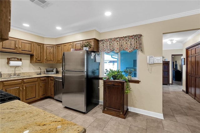 kitchen with light stone countertops, ornamental molding, stainless steel appliances, sink, and light tile patterned flooring